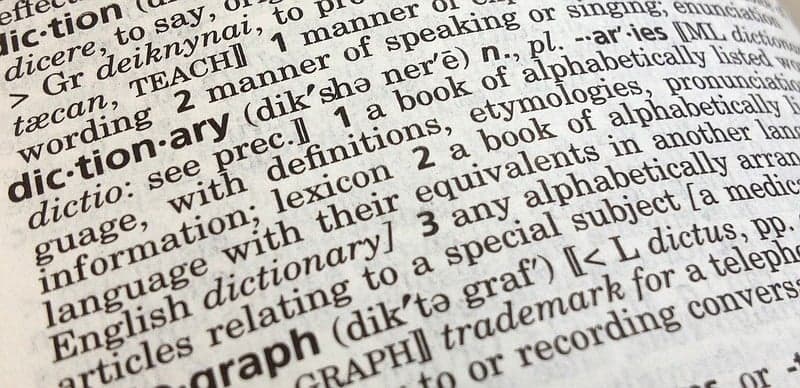 A dictionary open at the page containing the word dictionary