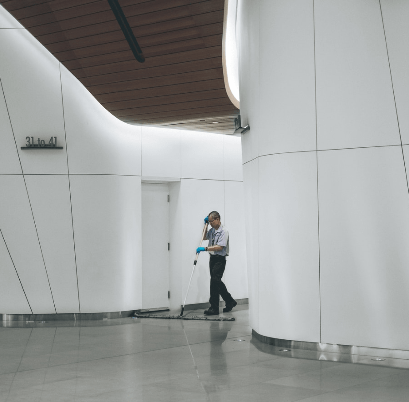 A cleaning supplier working in the lobby area of a building